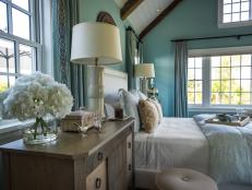 The master bedroom takes color cues from sea glass hues incorporated into geometric patterns, luxurious linens and eye-catching accessories.
