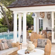 Enchanting Back Patio With Pool and Wicker Chairs 