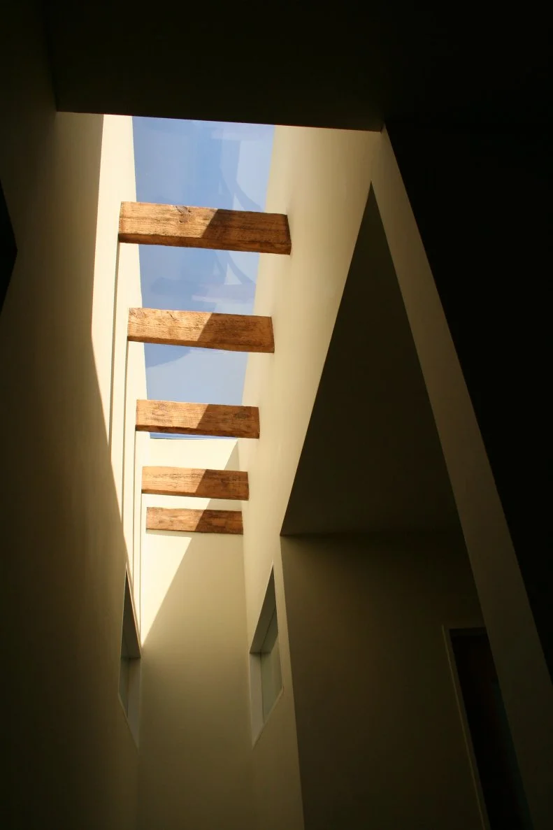 Contemporary Neutral Hallway With Long Skylight and Wood Dividers