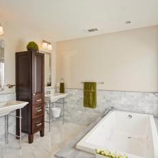 Cream Bathroom With Twin Sinks and Tall, Brown Cabinet