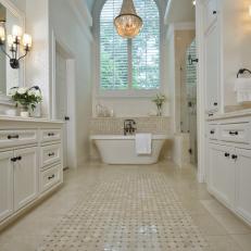 All-White Master Bathroom With Chandelier and Bathtub