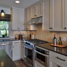 Open Kitchen With Dark Granite Countertops