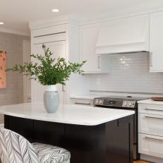 A Clean and Streamlined Kitchen With White Tile Backsplash