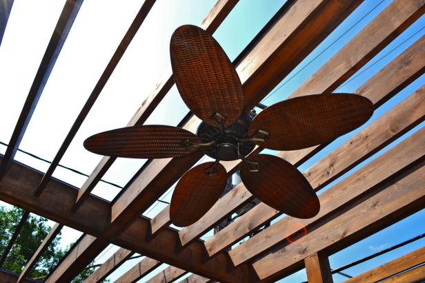 Outdoor fan hanging from pergola