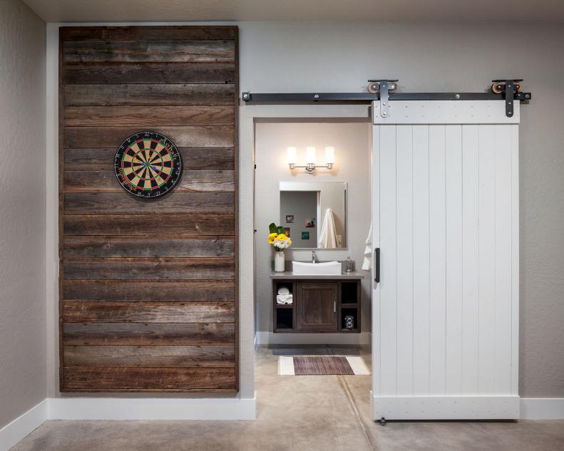 Neutral Game Room With Reclaimed Wood Wall Panel and Sliding Barn Door