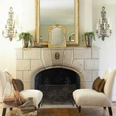 Sitting Area With Stone Fireplace and Gold Framed Mirrors