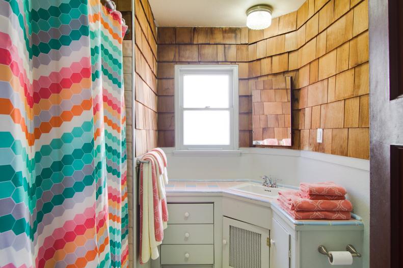 Small Bathroom With Colorful Shower Curtain & Wood Siding 