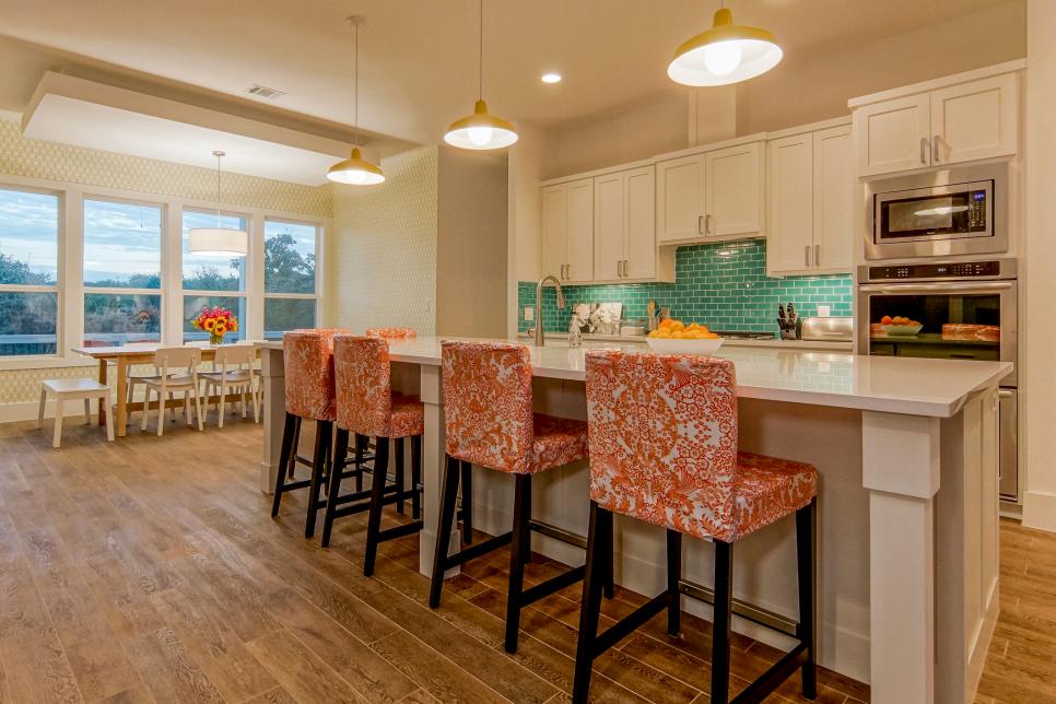 White Kitchen With Blue Backslash and Floral-Pattern Barstools