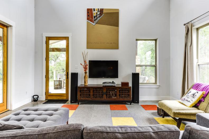 Modern Living Room with Bare Windows and Gray Rug 