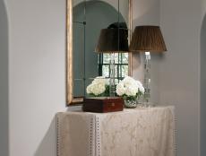 Neutral Transitional Foyer With Neutral Table and Gold Mirror