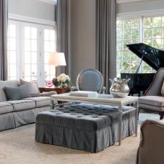 Formal Living Room With Gray Velvet Ottoman 