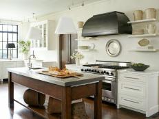 White Kitchen With Brown Wood Island and White Pendants