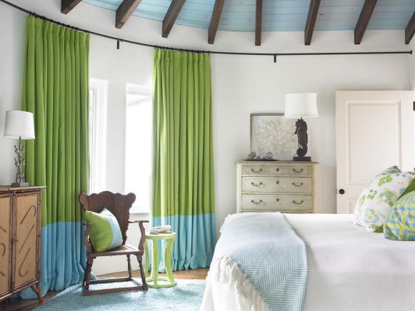 Coastal Bedroom With White Bedding and Blue and Green Accents