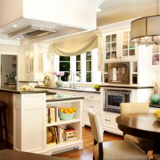 Charming White Eat-In Kitchen With Two-Tiered Island