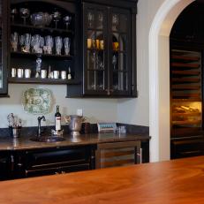 Sophisticated Wet Bar With Dark Glass-Front Cabinets