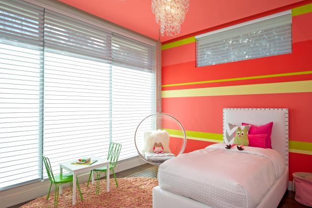 Pink Modern Girl's Bedroom With Hanging Chair and White Bed