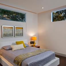 Streamlined Bedroom With Yellow Accents