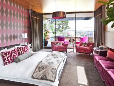 Bedroom With Pink and Brown Patterned Wall and White Bedding