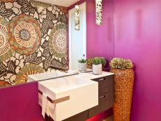 Eclectic Magenta Bathroom With Patterned Accent Wall and Small Vanity
