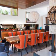 Contemporary Dining Space With Bold Orange Chairs