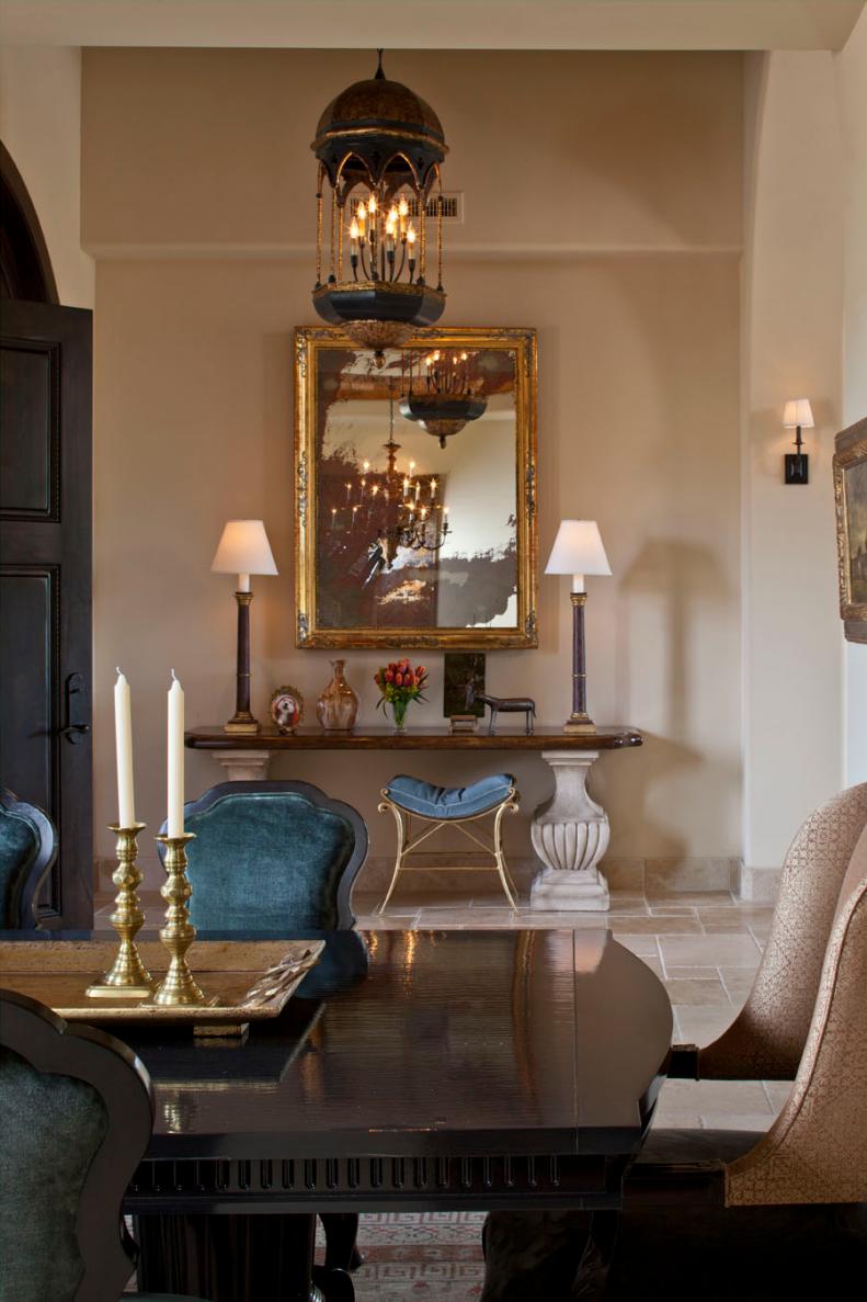 Mediterranean Entryway With Chandelier and Gold Mirror