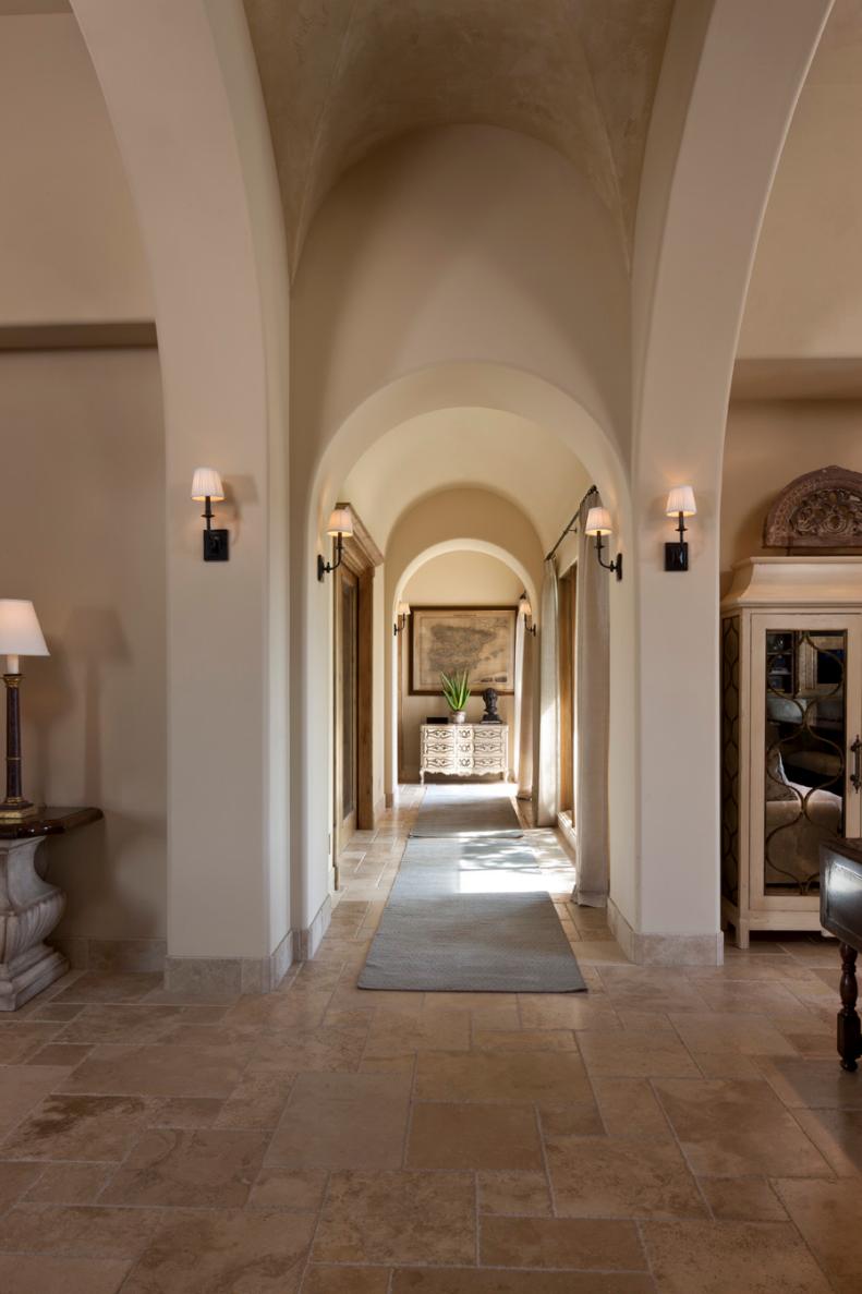 Mediterranean Foyer With Stone Archways and Tile Floor