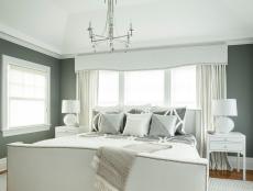 Transitional Gray Bedroom With White Furnishings