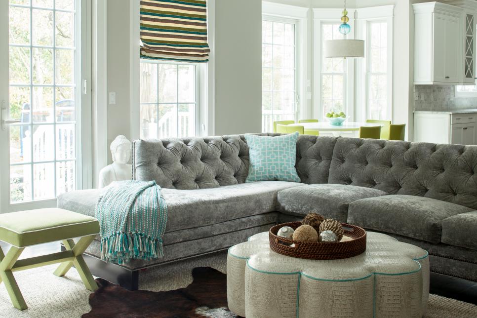 Gray Family Room With Gray Sofa and Scalloped Ottoman