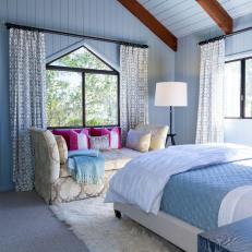Chic Transitional Bedroom Features Airy Blue Motif And Seating Area