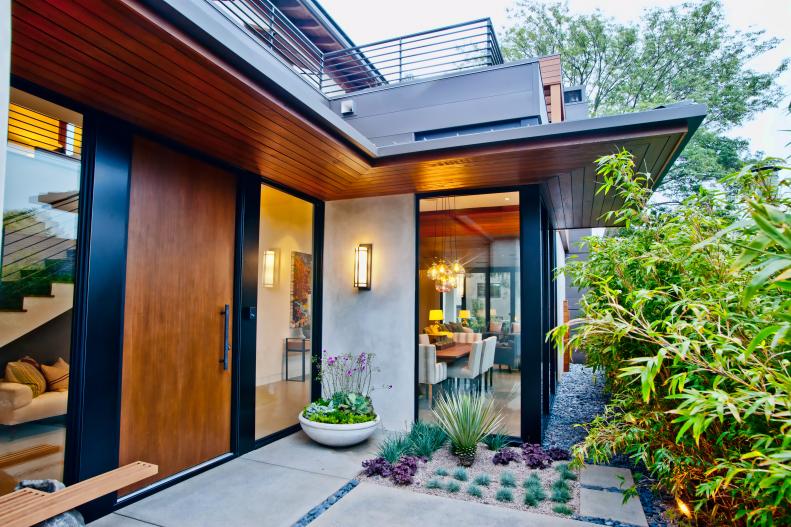 Contemporary Home Exterior With Floor-to-Ceiling Windows and Wood Door