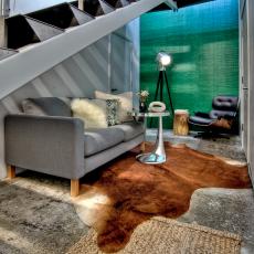 Bright Eclectic Office Sitting Area Features Gray Sofa and Animal Hide Rug