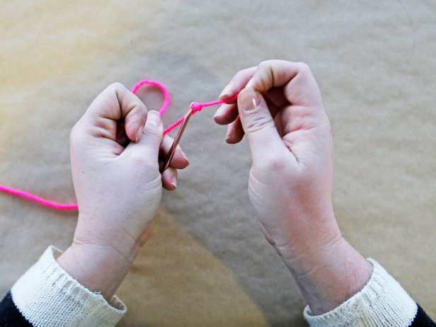 Step 2: Tie the end of the yarn to the crochet needle.