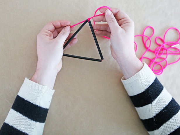 Step 4: Form straws into a triangle, then loop the string around in a loose knot. You want to leave just a little give to allow the ornament to take shape.