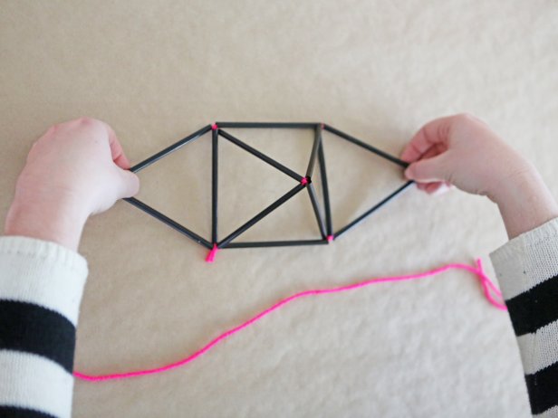 Step 7: Using a second length of string, tie the two side triangles together underneath to finish the diamond shape.