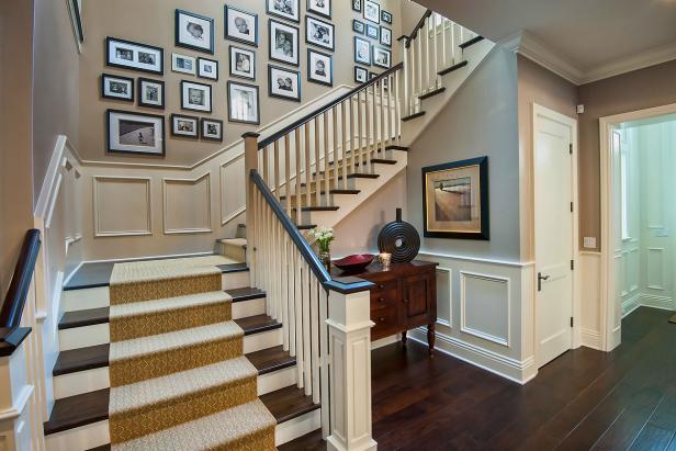 Traditional Foyer & Staircase With Black and White Photo Wall
