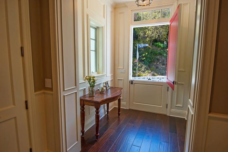 Traditional Home Entry With White Wainscoted Walls And Dutch Door.
