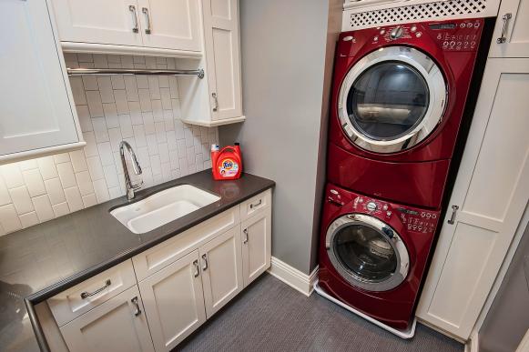 Gray And White Laundry Room With Red Washer and Dryer