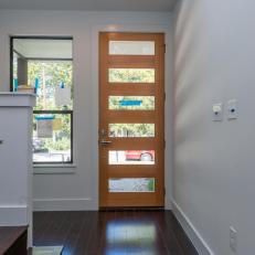 Modern Entryway Features Sleek Wooden Front Door