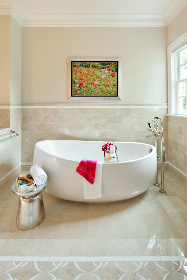 Neutral Master Bathroom With Large Oval Soaking Tub & Colorful Artwork