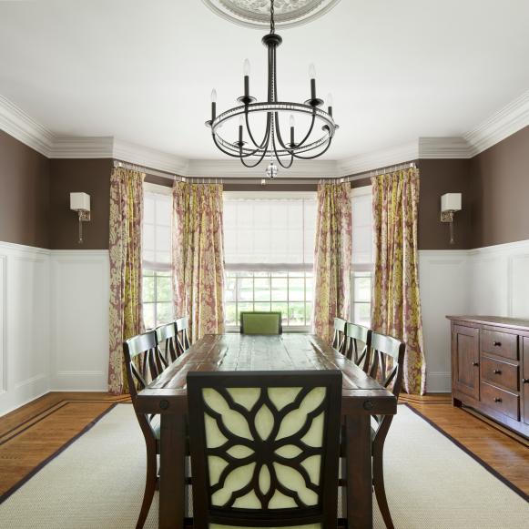 Brown Dining Room With Wainscoting and Wooden Dining Table
