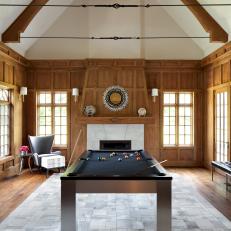 Wood Paneled Game Room With Sleek Pool Table