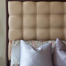 Beige Upholstered Headboard With Gray Textured Pillows 