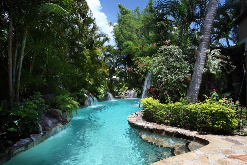 Lagoon Pool With Palm Trees, Shrubs and Waterfalls 