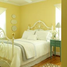 Yellow Cottage-Style Bedroom With White Iron Bed