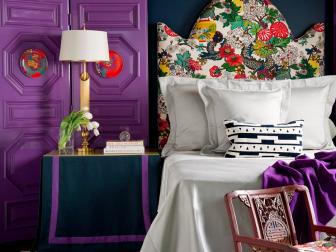 Navy Blue Bedroom With Purple Folding Screen and Colorful Headboard