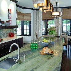 Eat-In Kitchen With Green Stone Island Countertop and Open Floor Plan