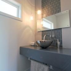 Modern Bathroom With Gray Tile Accent Strip and Stainless Steel Vessel Sink