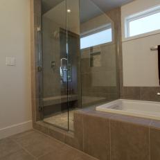 Modern Spa Bathroom With Large Glass Shower Next to Soaker Tub