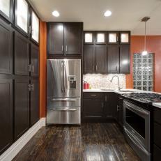 Contemporary Kitchen With Dark Wood Cabinets, Hardwood Flooring and Orange Walls 