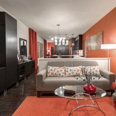 Bold Orange Living Room Features Dark Cabinetry 
